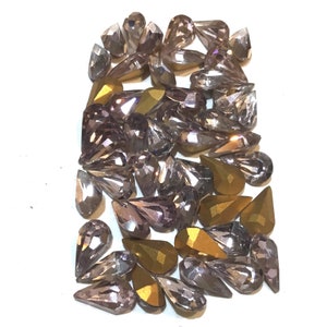Vintage Swarovski 10x6 rhinestones. Light Amethyst color. Gold foiled pointed back. 50 count.