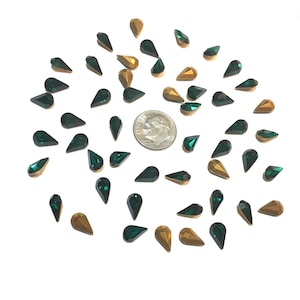 Vintage Swarovski 10 x 6 rhinestones. Emerald color. Gold foiled pointed back. 50 count.