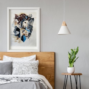 May include: A white framed abstract painting with blue, brown, and white colours hangs above a wooden headboard with a white and grey patterned pillow on a bed with a black and white patterned bedspread.