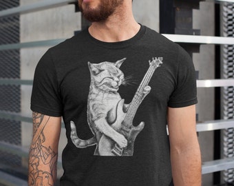 May include: A black t-shirt featuring a white graphic of a cat playing an electric guitar.