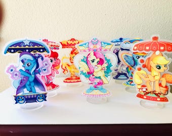 May include: Set of 7 My Little Pony cake toppers. Each topper features a different pony character with a colourful design and a clear plastic base.