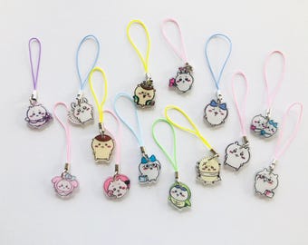 May include: A collection of 12 colorful keychains with various cartoon animal charms. The charms are made of clear plastic and feature different animal designs, including a bunny, a bear, a cat, and a dog. The keychains are attached to colorful strings.