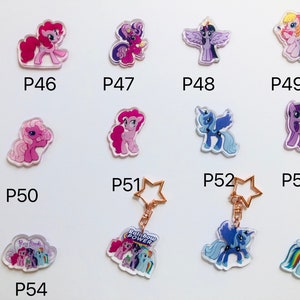 May include: A set of 10 My Little Pony keychains featuring different characters. The keychains are made of clear acrylic and feature colorful images of the ponies. The keychains are numbered P46 through P54.