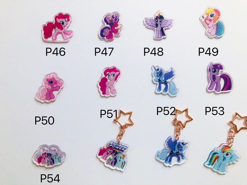 May include: A set of 10 My Little Pony keychains featuring different characters. The keychains are made of clear acrylic and feature colorful images of the ponies. The keychains are numbered P46 through P54.