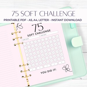 May include: A printable 75 day soft challenge tracker in a pink and white planner with gold rings. The tracker has a start date and end date section and a you did it! message at the bottom.