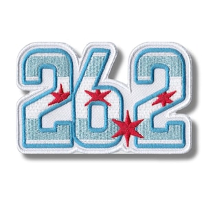 May include: A white, blue, and red embroidered patch with the number 262. The numbers are outlined in blue and have a white background. The patch features the Chicago flag colors and stars.