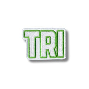 May include: White embroidered patch with the word "TRI" in green outline.