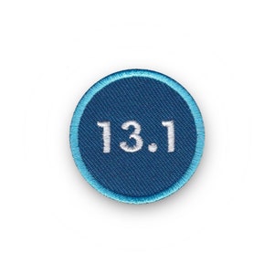 May include: A blue and white embroidered patch with the number 13.1.