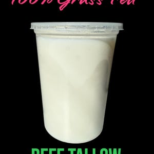 May include: A clear plastic container filled with white beef tallow, set against a black backdrop. The text "100% Grass Fed" is in pink script above, and "BEEF TALLOW" is in green block letters below.