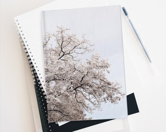 serene winter journal with tree branches baby blue sky warm colored branches layered with cool white snow for a beautiful pastel finish
