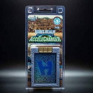 May include: A collectible card in a clear plastic case. The card features a blue and teal design with the text "RUINS REALM ACCELECHARGER" and "KRAZY 8 CUSTOMS". The card has a gold-colored top.