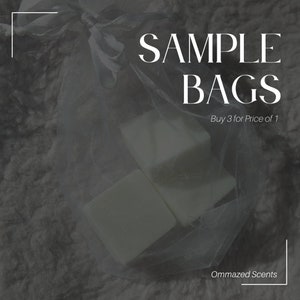 May include: Two white wax melts in a clear mesh bag. The bag is tied with a white ribbon. The text "SAMPLE BAGS" is written in white on a black background. The text "Buy 3 for Price of 1" is written in white on a black background. The text "Ommazed Scents" is written in white on a black background.