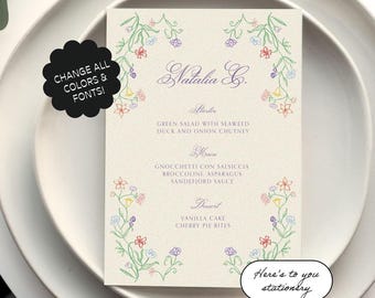 May include: A floral-themed menu card with the name "Natalia G." at the top. The menu includes a starter, main course, and dessert. The text "Here's to you stationery" is at the bottom of the card.
