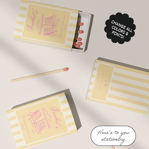 May include: Two yellow and white striped matchboxes with pink text and illustrations of beach chairs. The text on the boxes reads "Isabel's" and "Lost toast on the coast". The boxes are on a white surface with a matchstick and a black circle with white text that reads "CHANGE ALL COLORS & FONTS!"