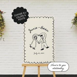 May include: A white sign with black scalloped edges and a black and white illustration of a couple holding hands and forming a heart shape. The text "Junie + Beau" and "July 22, 2024" is written in black cursive. The sign is on a wooden easel.
