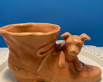 Vintage Shawnee pottery puppy on the woman’s boot planter.