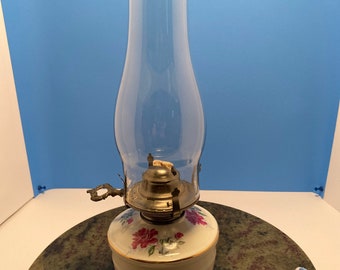 Oil lamp with roses.  Globe included. 13 3/4” tall.