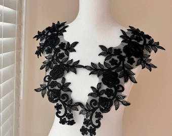 May include: Black floral lace applique with a delicate design featuring intricate leaves and flowers. This lace trim is perfect for adding a touch of elegance to any garment or craft project.