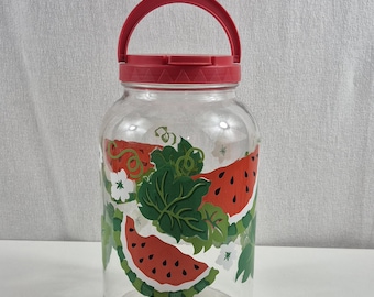 Vintage Glass Watermelon Sun Tea jar featuring a red lid and spigot for dispensing beverages.