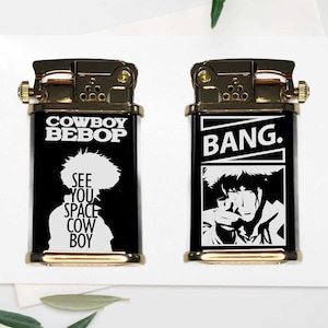 May include: Two black and gold lighters with white text and graphics. One lighter says "COWBOY BEBOP" and "SEE YOU SPACE COWBOY" with a silhouette. The other says "BANG" with a graphic of a person.