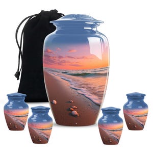 May include: A collection of blue cremation urns with a beach scene design. The set includes a large urn, a black velvet bag, and four smaller keepsake urns. The beach scene features a sunset over the ocean with seashells on the sand.