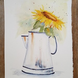 May include: A watercolor painting of a sunflower in a white pitcher with a blue rim. The sunflower is yellow with a brown center and green leaves. The pitcher has a rustic, aged look. The background is a light yellow with watercolor splatters.