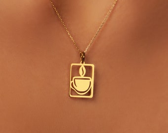 May include: A gold chain necklace with a pendant featuring a stylized coffee cup design inside a rectangular frame.