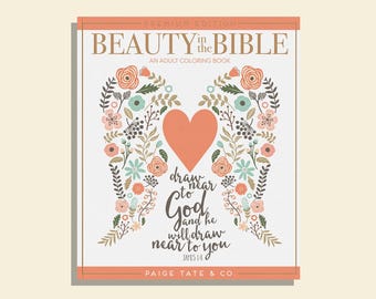 May include: A square adult coloring book titled "Beauty in the Bible." The cover features a peach heart and floral wing design. Text includes "Draw near to God and he will draw near to you" and "Paige Tate & Co."
