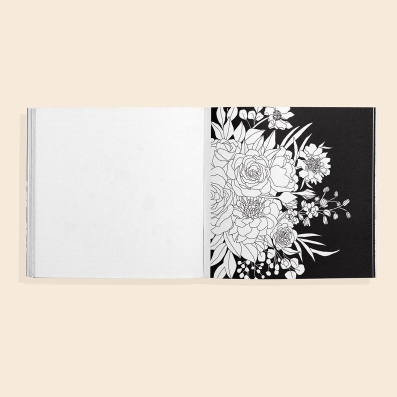 May include: An open coloring book with a black page featuring a line drawing of a bouquet of flowers. The opposite page is blank, ready for coloring.