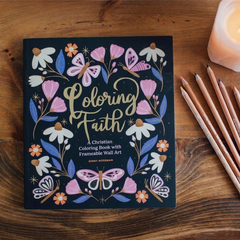 May include: A square coloring book titled Coloring Faith: A Christian Coloring Book with Frameable Wall Art by Ginny Mossman. The black cover features a floral and butterfly pattern in pink, white, blue, and orange with gold cursive lettering.