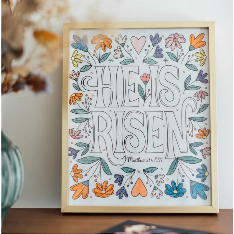 Perforated pages are perfect for framing your colored in pages. This shows a picture of a framed coloring page that says "He is Risen".