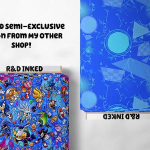 May include: Two fabric swatches, one with a blue background and a geometric pattern, and the other with a blue background and a pattern of Sonic the Hedgehog characters. The text "R&D INKED" is printed on both swatches.