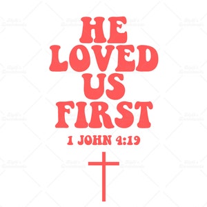 May include: Red text on a white background reads "He loved us first" with the Bible verse "1 John 4:19" below. A red cross is at the bottom of the image.