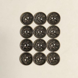May include: A set of twelve round metal buttons arranged in a grid. Each button features a raised, antique bronze-toned finish with a detailed embossed design of a thistle plant, including leaves and a flower head, and two central sewing holes.