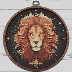 May include: A brown wooden embroidery hoop with a black background and a detailed image of a lion with a golden mane. The lion's face is centered in the hoop and the background is filled with stars.