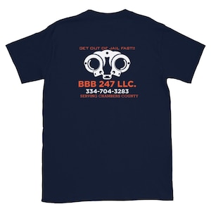 May include: Navy blue t-shirt with white text that reads "Get out of jail fast!" and a white illustration of handcuffs. The text "BBB 247 LLC. 334-704-3283 SERVING CHAMBERS COUNTY" is also printed in white.