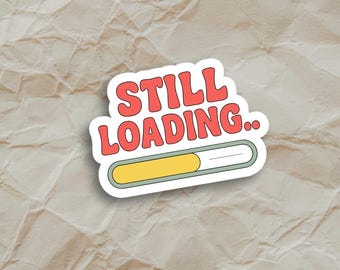 May include: A sticker with a progress bar that says "STILL LOADING..." in red letters on a white background.