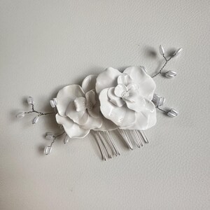 Double Flor hair comb. Bridal hair comb, hand crafted white clay flowers, and pearl accents. Perfect to accessorize any wedding bridal updo.
