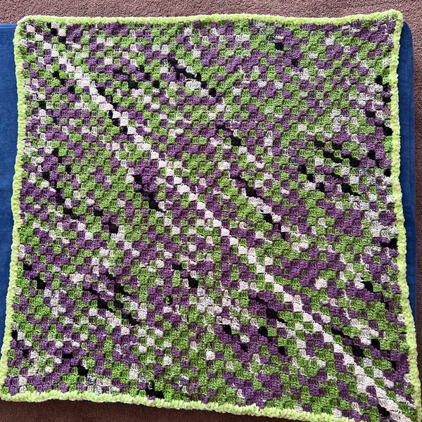 C2C crochet baby afghan in Big Twist Witches Potion.  The border and diagonal line thru the middle are made using glow in the dark yarn.
