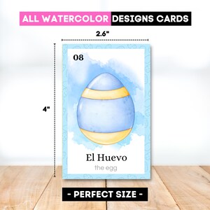 May include: A watercolor design card, 4" x 2.6", featuring a blue egg with yellow stripes, labeled "El Huevo" (the egg). The card has a light blue border and the text "ALL WATERCOLOR DESIGNS CARDS".