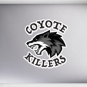May include: A white laptop sticker with a black and gray coyote head illustration. The text "COYOTE KILLERS" is in a black circle around the coyote head.