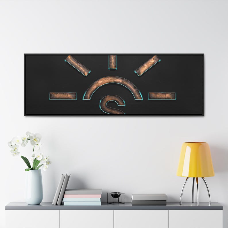 May include: A black framed wall art piece with a copper coloured sun design on a black background. The sun has a blue outline and a copper coloured S in the centre.