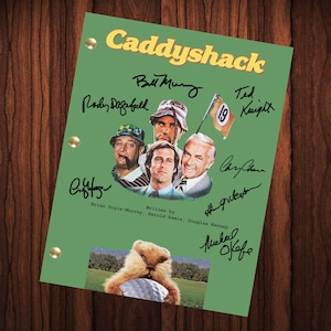 May include: A green script cover with the title "Caddyshack" in yellow letters. The cover features photos of the actors from the film, including Bill Murray, Rodney Dangerfield, Chevy Chase, and Ted Knight. The cover also includes the signatures of the actors.