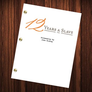 May include: A white script cover with the title "12 Years a Slave" in orange and grey text. The text "Screenplay by John Ridley" is also included in grey text.