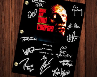 May include: A black and white script for the movie "House of 1000 Corpses" with signatures from the cast and crew, including Rob Zombie, Sid Haig, Bill Moseley, and Tom Towles.