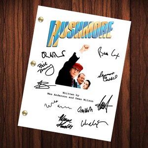 May include: A white script with the title "Rushmore" in blue and yellow letters. The script is signed by the cast and crew, including Bill Murray, Owen Wilson, and Wes Anderson.