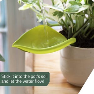 May include: A lime green leaf-shaped plant watering funnel inserted into a potted plant. The funnel directs water into the soil. The text on the image reads: Stick it into the pot's soil and let the water flow!