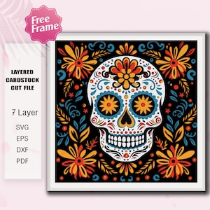 Może przedstawiać: Oprawiony, warstwowy plik do wycinania z kartonu z kolorowym wzorem czaszki cukrowej. Biała czaszka ma skomplikowane wzory kwiatowe i wirujące w kolorze pomarańczowym, żółtym, niebieskim i turkusowym na czarnym tle. Zawiera tekst "Free Frame".