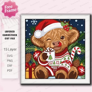 May include: A layered cardstock cut file featuring a brown Highland cow wearing a red Santa hat and a patterned sweater. The cow holds a mug with a tree design, surrounded by pine branches, red ornaments, a gift, and a candy cane.