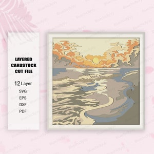 May include: A layered cardstock cut file design of a sunset over the ocean. The design features a layered effect with 12 layers, creating a 3D effect. The colors are warm and inviting, with shades of orange, yellow, blue, and brown.